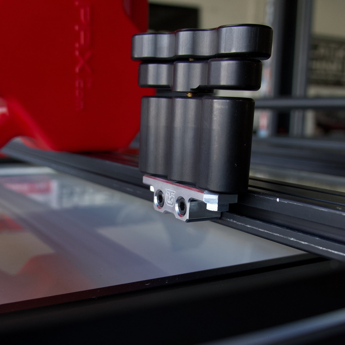 Billet aluminum Rotopax mount adapter for extrusion roof rack cross bars.